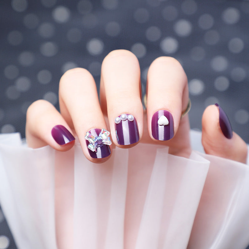 Wearing Nails With Diamonds And Purple Fake Nails - Image 2